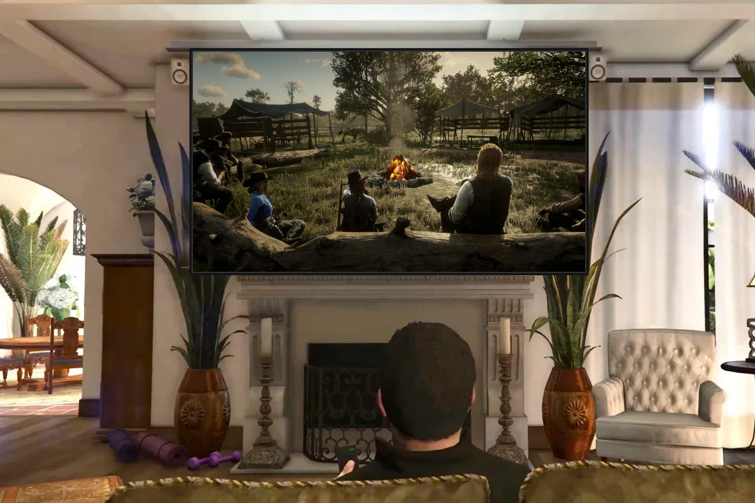 A GTAV character watches a TV displaying a group of RDR2 characters sitting around a campfire.